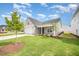 Charming single-Gathering home with a gray exterior, attached garage, and well-manicured lawn at 66 W Emily Gardens Dr, Selma, NC 27576