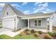 Charming single-Gathering home with a gray exterior, attached garage, and well-manicured lawn at 66 W Emily Gardens Dr, Selma, NC 27576