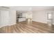 Open-concept living room featuring hardwood floors, recessed lighting, and gray kitchen cabinets at 66 W Emily Gardens Dr, Selma, NC 27576