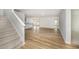 Open-concept living room with light-colored walls, hardwood floors, and a staircase at 66 W Emily Gardens Dr, Selma, NC 27576