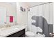 Small bathroom with a granite countertop, dark cabinets, and a shower with a dinosaur shower curtain at 6928 Leesville Rd, Raleigh, NC 27613