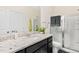Modern bathroom with a granite countertop vanity and glass-enclosed shower at 6928 Leesville Rd, Raleigh, NC 27613