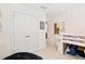 bedroom with bunkbed, beanbag chair, and white double doors to the closet at 6928 Leesville Rd, Raleigh, NC 27613