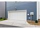 White garage door on blue siding at 6928 Leesville Rd, Raleigh, NC 27613