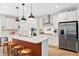 Stylish kitchen features granite countertops, stainless steel appliances, a spacious island, and custom cabinetry at 6928 Leesville Rd, Raleigh, NC 27613