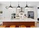 Modern kitchen with a large island, stainless steel appliances, and sleek white cabinets at 6928 Leesville Rd, Raleigh, NC 27613