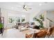 Bright living room with a comfortable sofa, ceiling fan, and neutral decor at 6928 Leesville Rd, Raleigh, NC 27613