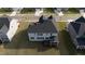 Aerial view of the home showing the roof, screened-in porch, and grassy backyard at 713 Ramsours Mill Dr, Holly Springs, NC 27540