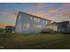 Large backyard with a deck and a view of the beautiful sunset at 713 Ramsours Mill Dr, Holly Springs, NC 27540