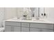 Bathroom featuring a double vanity with grey cabinetry and modern fixtures at 713 Ramsours Mill Dr, Holly Springs, NC 27540