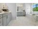 Elegant bathroom with marble floors, double vanity, soaking tub, and a bright window view at 713 Ramsours Mill Dr, Holly Springs, NC 27540