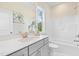 This bathroom features a vanity sink, a tub and shower combination, and a mirror with stylish accents at 713 Ramsours Mill Dr, Holly Springs, NC 27540