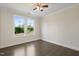Well-lit bedroom with hardwood flooring, crown molding, and large windows offering a pleasant view at 713 Ramsours Mill Dr, Holly Springs, NC 27540