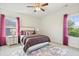 Bedroom with a plush bed, matching nightstands, and natural light filtering through the windows at 713 Ramsours Mill Dr, Holly Springs, NC 27540
