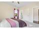 Bright bedroom featuring windows and a bed with carpet at 713 Ramsours Mill Dr, Holly Springs, NC 27540