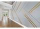 Grand foyer with a striking accent wall and hardwood floors, creating a lasting first impression at 713 Ramsours Mill Dr, Holly Springs, NC 27540