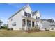 Charming home with a covered porch, stone accents, and lush green lawn, offering a welcoming curb appeal at 713 Ramsours Mill Dr, Holly Springs, NC 27540