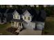 Stunning two-story home with a three-car garage and beautiful landscaping at sunset at 713 Ramsours Mill Dr, Holly Springs, NC 27540