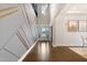 Bright foyer with decorative wall trim, chandelier, and a view of the staircase at 713 Ramsours Mill Dr, Holly Springs, NC 27540