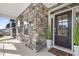 Charming front door with stone accents and a welcoming porch at 713 Ramsours Mill Dr, Holly Springs, NC 27540