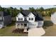 Front exterior of the home, showing the front porch, stone and siding details, and two-car garage at 713 Ramsours Mill Dr, Holly Springs, NC 27540