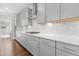 Contemporary kitchen with gray cabinets, sleek countertops, stainless steel appliances, and stylish backsplash at 713 Ramsours Mill Dr, Holly Springs, NC 27540