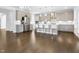 Modern kitchen with stainless steel appliances, island seating, and hardwood floors at 713 Ramsours Mill Dr, Holly Springs, NC 27540