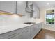 Elegant kitchen featuring modern appliances, quartz countertops, and gray cabinetry at 713 Ramsours Mill Dr, Holly Springs, NC 27540