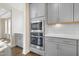 Kitchen features stainless steel appliances, lots of cabinets, and hardwood floors at 713 Ramsours Mill Dr, Holly Springs, NC 27540