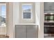 Kitchen features a built-in oven, microwave, and gray cabinets, with natural light streaming in through a window at 713 Ramsours Mill Dr, Holly Springs, NC 27540