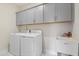 Laundry room featuring full-size washer and dryer hookups, sink and plenty of cabinet space at 713 Ramsours Mill Dr, Holly Springs, NC 27540