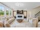 Inviting living room featuring comfortable sofas, a modern fireplace, and stylish decor, ideal for relaxation and entertainment at 713 Ramsours Mill Dr, Holly Springs, NC 27540