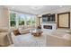 Bright living room featuring large windows, fireplace, and modern decor at 713 Ramsours Mill Dr, Holly Springs, NC 27540