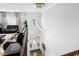 View from a staircase of a bright living room with hardwood floors and comfortable leather furniture at 713 Ramsours Mill Dr, Holly Springs, NC 27540