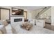 Elegant living room with fireplace, staircase and modern decor at 713 Ramsours Mill Dr, Holly Springs, NC 27540