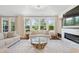 Inviting living room with large windows, modern fireplace, and stylish furniture at 713 Ramsours Mill Dr, Holly Springs, NC 27540