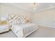 Beautiful main bedroom with an eye-catching headboard, plush carpet, and side tables with lamps at 713 Ramsours Mill Dr, Holly Springs, NC 27540