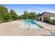 Bright pool with deck chairs and covered seating area surrounded by lush greenery at 713 Ramsours Mill Dr, Holly Springs, NC 27540