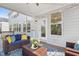 This is a lovely screened in porch with wicker furniture and string lights at 713 Ramsours Mill Dr, Holly Springs, NC 27540