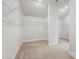 Spacious walk-in closet with wire shelving and neutral carpet at 713 Ramsours Mill Dr, Holly Springs, NC 27540