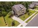 Bird's eye view of this home with a long driveway, well manicured lawn and professional landscaping at 728 Peninsula Forest Pl, Cary, NC 27519