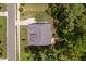 Birds eye view of house with driveway, manicured lawn and wooden deck nestled in trees at 728 Peninsula Forest Pl, Cary, NC 27519