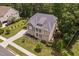 Stunning aerial view of home with a manicured front yard, stone facade and inviting porch at 728 Peninsula Forest Pl, Cary, NC 27519