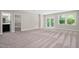 A basement space with neutral walls, carpet floors, large windows, and an attached bathroom at 728 Peninsula Forest Pl, Cary, NC 27519