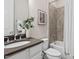 Well-lit bathroom featuring tile shower, vanity with sink, and modern fixtures at 728 Peninsula Forest Pl, Cary, NC 27519