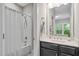 Cozy bathroom with a shower and tub combo, dark vanity and towel and soap accessories at 728 Peninsula Forest Pl, Cary, NC 27519