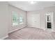 Inviting bedroom with plush carpeting, natural light, and access to an ensuite bathroom at 728 Peninsula Forest Pl, Cary, NC 27519
