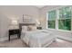 Cozy bedroom with natural light, plush carpet, and neutral decor for a relaxing ambiance at 728 Peninsula Forest Pl, Cary, NC 27519