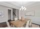 Spacious dining room with tray ceiling, decorative chandelier, and seating for six at 728 Peninsula Forest Pl, Cary, NC 27519