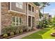 Beautiful exterior view showing the home's stone facade and inviting walkway leading to the front door at 728 Peninsula Forest Pl, Cary, NC 27519